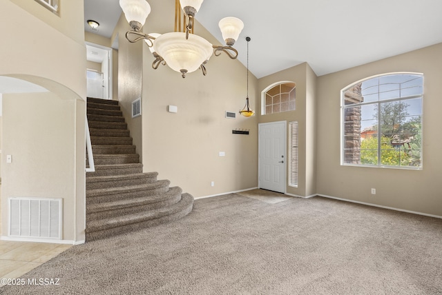 6783 W Alegria Dr, Tucson, AZ 85743 - foyer entrance with a high ceiling, stairway, baseboards, and carpet flooring