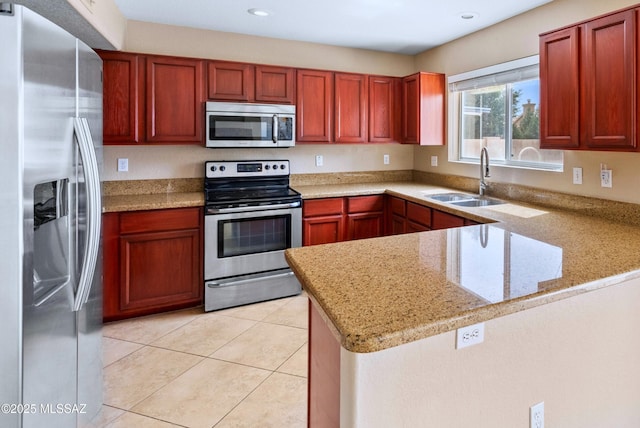 6783 W Alegria Dr, Tucson, AZ 85743 - kitchen with stainless steel appliances, a sink, a peninsula, light stone counters, and recessed lighting
