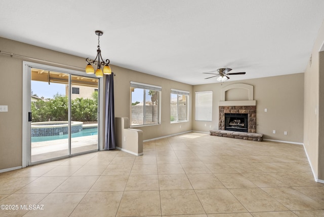 6783 W Alegria Dr, Tucson, AZ 85743 - unfurnished living room with ceiling fan, baseboards, light tile patterned floors, and a fireplace