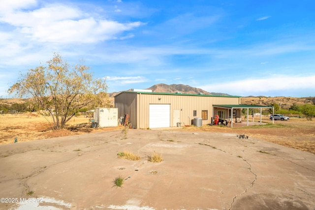 2 Sunset Dr, Elgin, AZ 85611 - detached garage featuring a mountain view, concrete driveway, and central AC