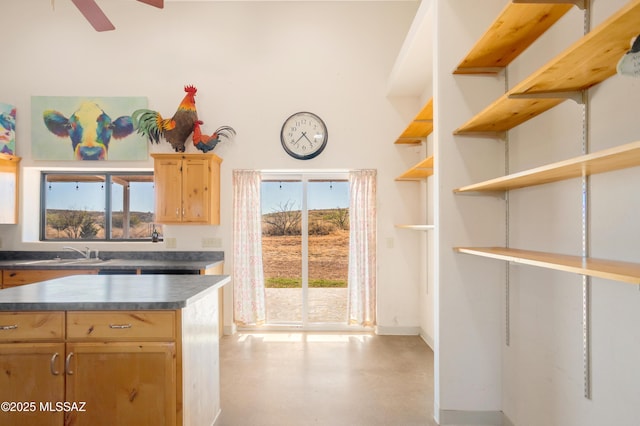 2 Sunset Dr, Elgin, AZ 85611 - kitchen featuring dark countertops, open shelves, light brown cabinetry, a sink, and a ceiling fan