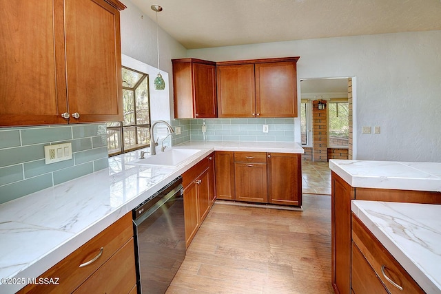 8932 N Rasmussen Ave, Tucson, AZ 85742 - kitchen with a sink, dishwasher, backsplash, brown cabinetry, and light stone countertops
