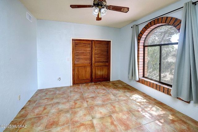 8932 N Rasmussen Ave, Tucson, AZ 85742 - unfurnished bedroom featuring a closet and a ceiling fan