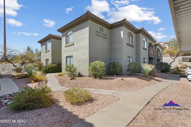 5751 N Kolb Rd # 22103, Tucson, AZ 85750 - view of home's exterior featuring a tile roof and stucco siding