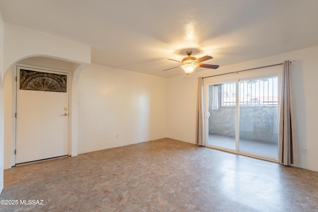 6335 N Barcelona Ln Unit 713, Tucson, AZ 85704 - empty room with arched walkways and a ceiling fan