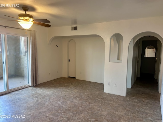 6335 N Barcelona Ln Unit 713, Tucson, AZ 85704 - empty room with arched walkways and ceiling fan