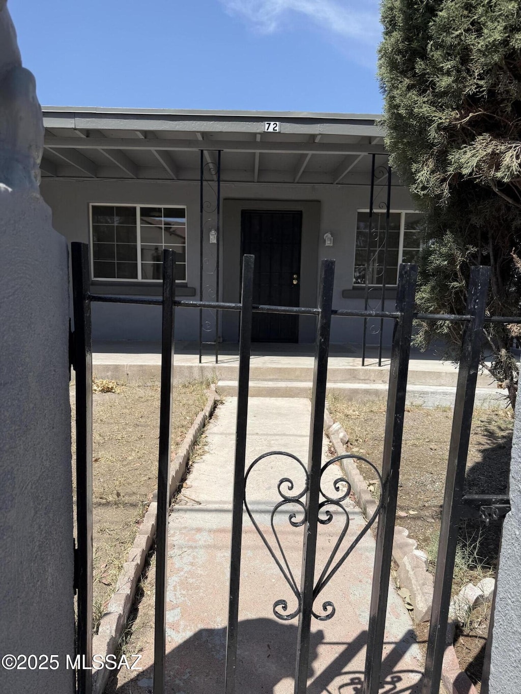 72 N Hereford Dr, Nogales, AZ 85621 - rear view of property featuring stucco siding, a gate, and a fenced front yard