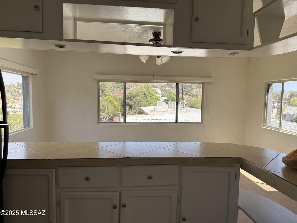 72 N Hereford Dr, Nogales, AZ 85621 - kitchen with tile countertops, plenty of natural light, and white cabinetry