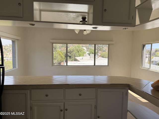 72 N Hereford Dr, Nogales, AZ 85621 - kitchen with tile countertops, plenty of natural light, and white cabinetry