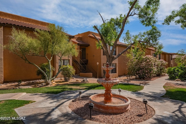 6651 N Campbell Ave Apt 221, Tucson, AZ 85718 - view of front facade featuring a tile roof, stucco siding, and stairway