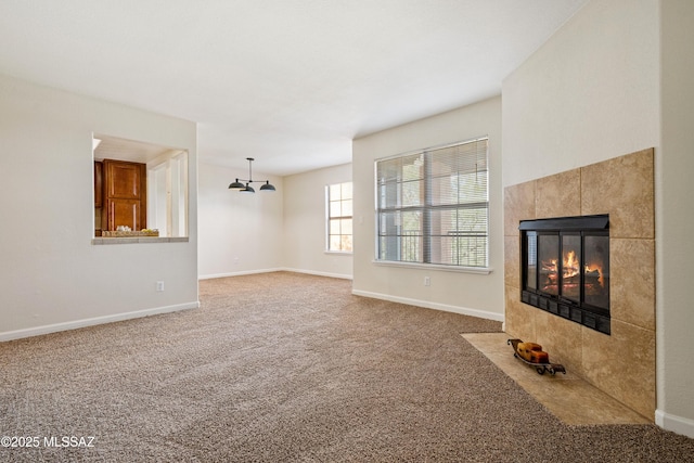 6651 N Campbell Ave Apt 221, Tucson, AZ 85718 - unfurnished living room featuring carpet, a fireplace, and baseboards