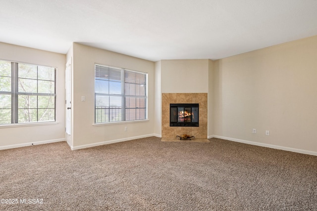 6651 N Campbell Ave Apt 221, Tucson, AZ 85718 - unfurnished living room featuring carpet flooring, a tile fireplace, and baseboards