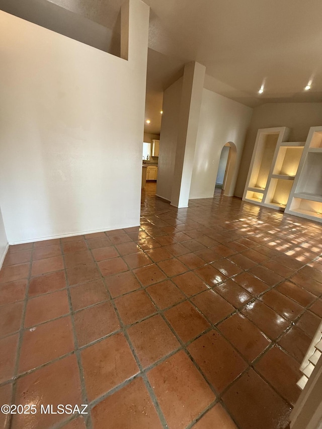 5640 N Placita Favorita, Tucson, AZ 85750 - unfurnished living room with arched walkways, baseboards, recessed lighting, and tile patterned flooring