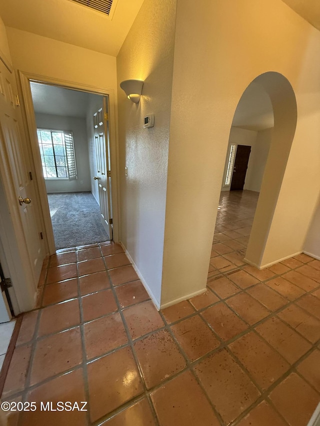 5640 N Placita Favorita, Tucson, AZ 85750 - corridor with arched walkways, baseboards, and tile patterned flooring