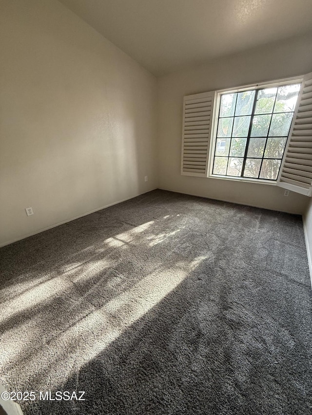 5640 N Placita Favorita, Tucson, AZ 85750 - empty room with carpet floors and vaulted ceiling