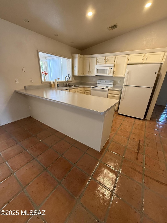 5640 N Placita Favorita, Tucson, AZ 85750 - kitchen featuring white appliances, a peninsula, lofted ceiling, light countertops, and recessed lighting
