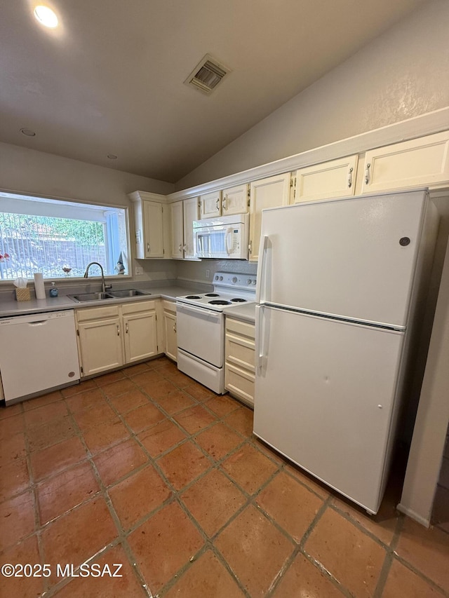 5640 N Placita Favorita, Tucson, AZ 85750 - kitchen with white appliances, a sink, vaulted ceiling, white cabinetry, and light countertops