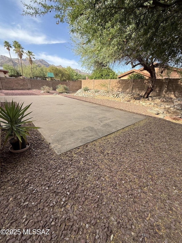 5640 N Placita Favorita, Tucson, AZ 85750 - fenced backyard featuring a mountain view and a patio area