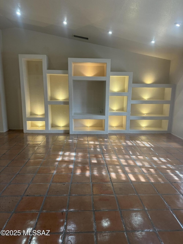 5640 N Placita Favorita, Tucson, AZ 85750 - unfurnished room with built in shelves, lofted ceiling, and baseboards