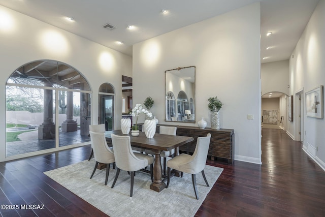 3750 E Sumo Quinto, Tucson, AZ 85718 - dining space with a high ceiling, wood-type flooring, baseboards, arched walkways, and recessed lighting