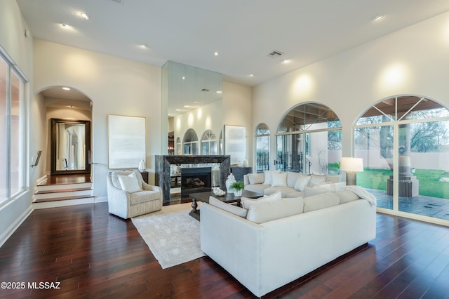 3750 E Sumo Quinto, Tucson, AZ 85718 - living area featuring dark wood-style floors, a fireplace, recessed lighting, and arched walkways