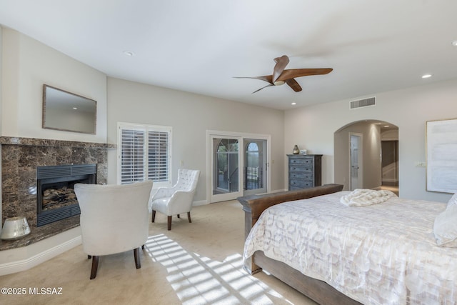 3750 E Sumo Quinto, Tucson, AZ 85718 - bedroom with light colored carpet, arched walkways, recessed lighting, a fireplace, and ceiling fan