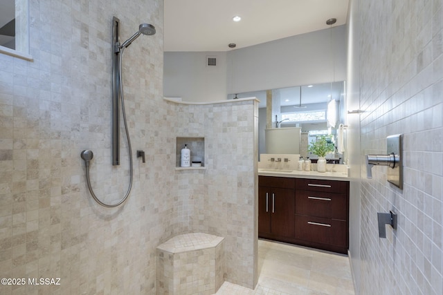 3750 E Sumo Quinto, Tucson, AZ 85718 - full bathroom featuring vanity, tiled shower, tile walls, recessed lighting, and tile patterned flooring