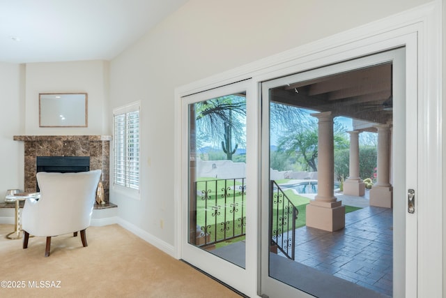 3750 E Sumo Quinto, Tucson, AZ 85718 - doorway to outside with healthy amount of natural light, a premium fireplace, light colored carpet, and baseboards