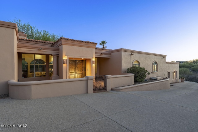 3750 E Sumo Quinto, Tucson, AZ 85718 - view of front facade featuring a gate, stucco siding, a tile roof, and a fenced front yard
