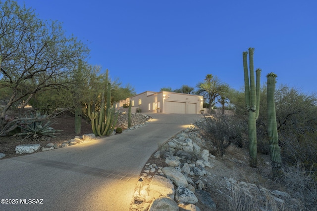 3750 E Sumo Quinto, Tucson, AZ 85718 - view of front of home featuring concrete driveway, a garage, and stucco siding