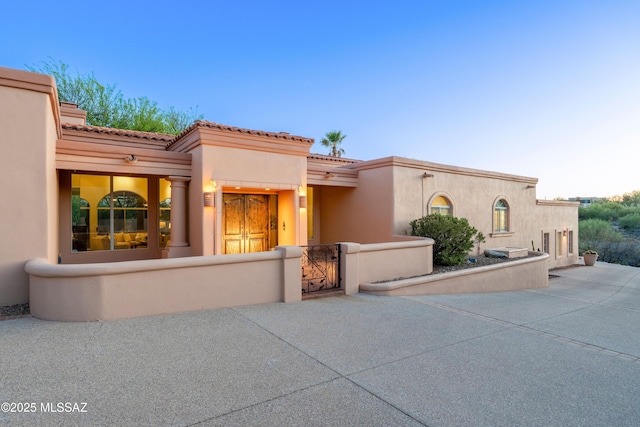 3750 E Sumo Quinto, Tucson, AZ 85718 - view of front of property featuring a gate, stucco siding, a fenced front yard, and a tile roof