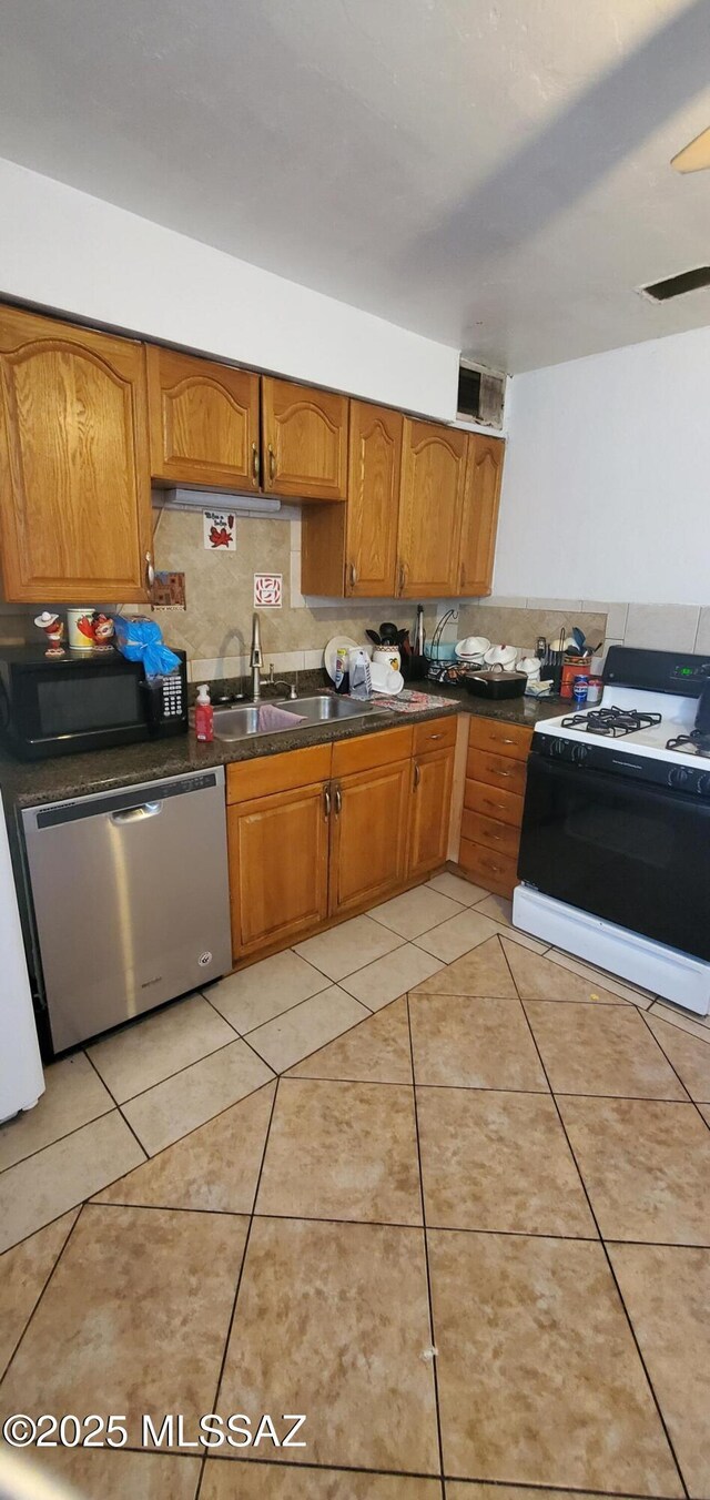 626 W Santa Paula St, Tucson, AZ 85706 - kitchen featuring gas stove, stainless steel dishwasher, black microwave, a sink, and brown cabinets