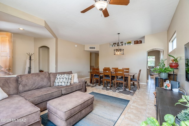 7511 W Sweet River Rd, Tucson, AZ 85743 - living area featuring arched walkways, a ceiling fan, light tile patterned floors, and baseboards