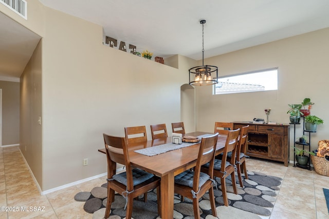 7511 W Sweet River Rd, Tucson, AZ 85743 - dining space featuring a chandelier, light tile patterned flooring, and baseboards