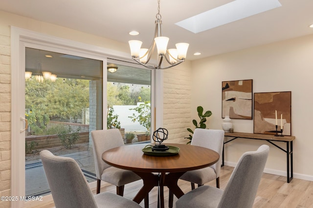 8628 N Placita Del Cardo, Tucson, AZ 85704 - dining space featuring a chandelier, light wood finished floors, a skylight, and recessed lighting