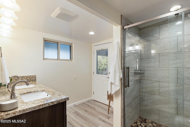 8628 N Placita Del Cardo, Tucson, AZ 85704 - full bathroom with wood finished floors, a shower stall, double vanity, baseboards, and recessed lighting