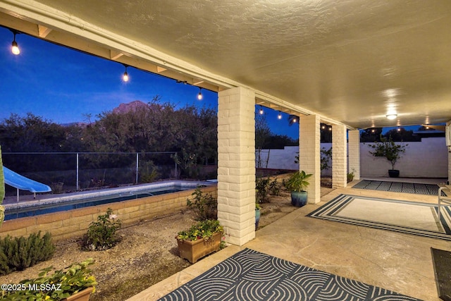8628 N Placita Del Cardo, Tucson, AZ 85704 - patio at twilight featuring a patio and a fenced backyard