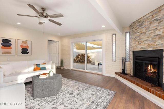 8628 N Placita Del Cardo, Tucson, AZ 85704 - living area featuring healthy amount of natural light, wood finished floors, ceiling fan, a warm lit fireplace, and recessed lighting