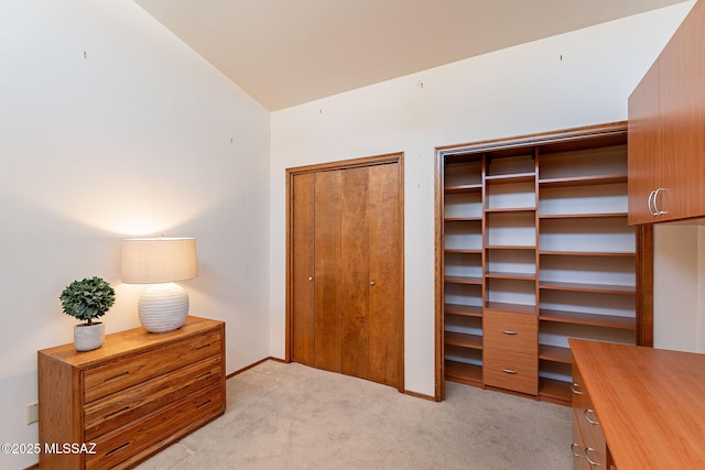 1900 E Campbell Ter, Tucson, AZ 85718 - bedroom featuring light carpet, multiple closets, a desk, and vaulted ceiling
