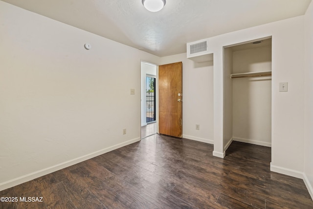 1716 S Sleepy Hollow Ave, Tucson, AZ 85710 - unfurnished bedroom featuring dark wood finished floors, baseboards, and a closet