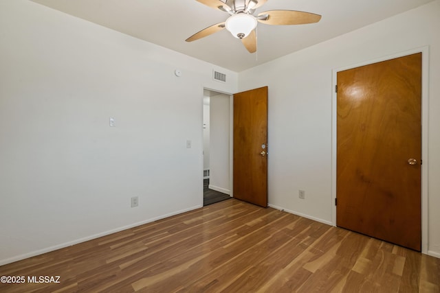 1716 S Sleepy Hollow Ave, Tucson, AZ 85710 - unfurnished bedroom featuring wood finished floors, baseboards, and a ceiling fan