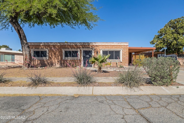 1716 S Sleepy Hollow Ave, Tucson, AZ 85710 - view of front of house with a carport and brick siding