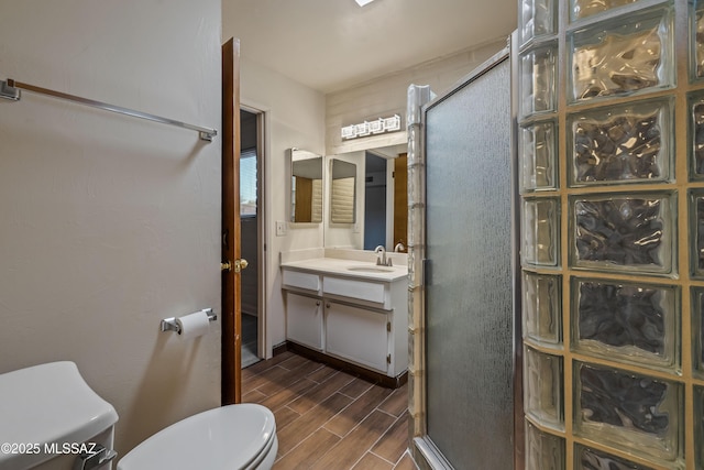 1716 S Sleepy Hollow Ave, Tucson, AZ 85710 - bathroom with toilet, vanity, a shower stall, and wood finished floors