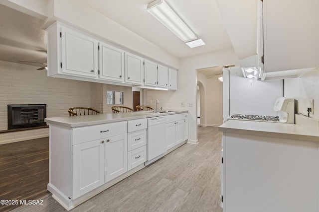 1716 S Sleepy Hollow Ave, Tucson, AZ 85710 - kitchen featuring white appliances, light wood-type flooring, white cabinets, and a sink
