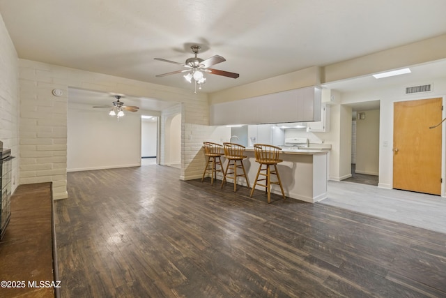 1716 S Sleepy Hollow Ave, Tucson, AZ 85710 - living area with dark wood-type flooring, a ceiling fan, and baseboards