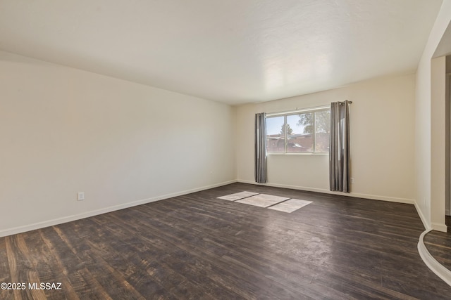 1716 S Sleepy Hollow Ave, Tucson, AZ 85710 - empty room with dark wood-type flooring and baseboards