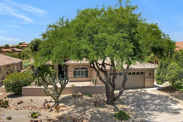 37358 S Ridgeview Blvd, Saddlebrooke, AZ 85739 - view of front facade featuring driveway, a tiled roof, stucco siding, and an attached garage