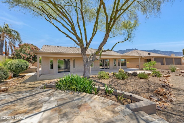 37358 S Ridgeview Blvd, Saddlebrooke, AZ 85739 - rear view of property with a patio area, a mountain view, stucco siding, and a tile roof