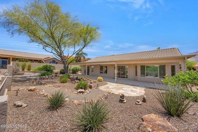 37358 S Ridgeview Blvd, Saddlebrooke, AZ 85739 - back of house with a tiled roof, a patio, and stucco siding