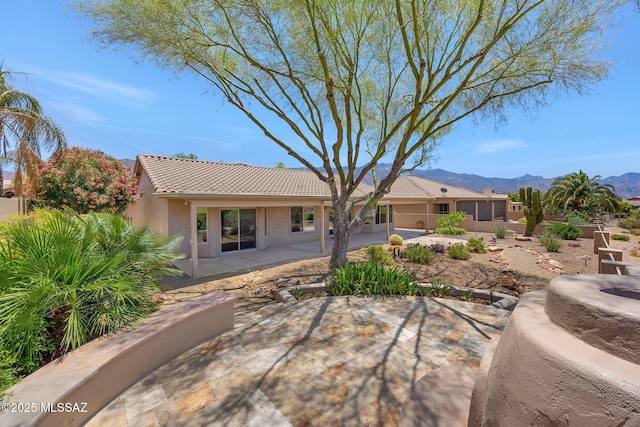 37358 S Ridgeview Blvd, Saddlebrooke, AZ 85739 - back of house featuring a patio area, a tile roof, a mountain view, and stucco siding